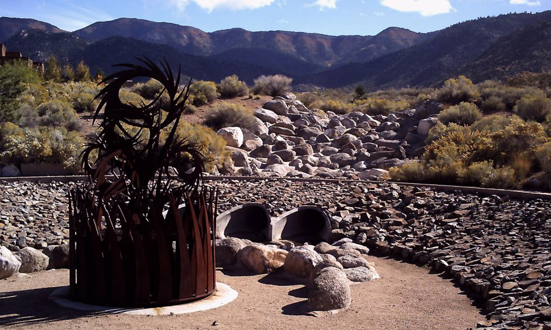 Mariposa development with large rock swale and water runoff management